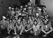 Crew with beards in working clothes around the 4 inch gun