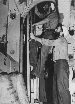 Pampanito ship's cook Joe Eichner (right) and electrician Duncan Brown climbing the crews mess ladder.